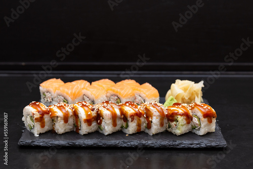 Sushi on a stone plate with black background