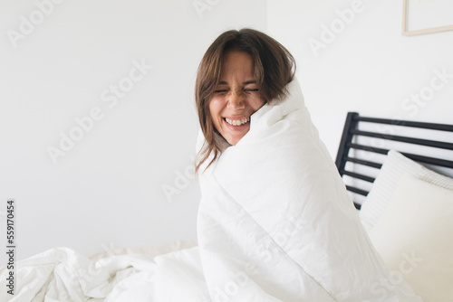 Happy Woman Cozy in Bed with Blankets Cold