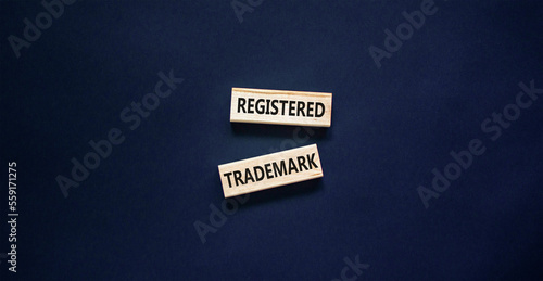 Registered trademark symbol. Concept word Registered trademark on wooden blocks. Beautiful black table black background. Business and registered trademark concept. Copy space.