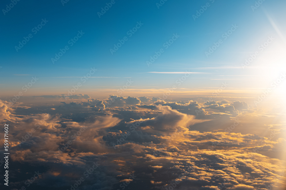 Natural background of sky, sunrise above dark clouds, view through window from inside of airplane during the flight. Natural background of sky, sunrise above dark clouds, view through window from inside of airplane during the flight.