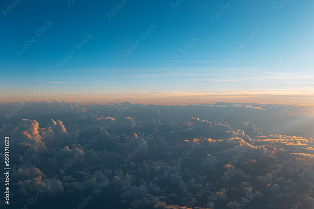 Natural background of sky, sunset above dark clouds, view from inside of airplane during the flight. Natural background of sky, sunset above dark clouds, view from inside of airplane during the flight.