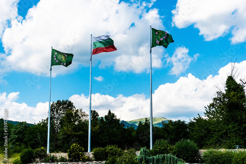 The Bulgarian flag and the flag of the Damascena rose-oil complex. Skobelevo, Bulgaria. photo