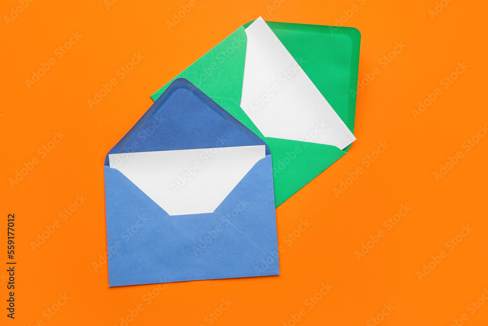 Paper envelopes with cards on orange background Paper envelopes with cards on orange background