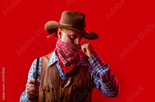 American bandit in mask, western man with hat. Portrait of man wearing cowboy hat, gun, macho. West, guns. Portrait of farmer or cowboy in hat. Portrait of a cowboy. American farmer