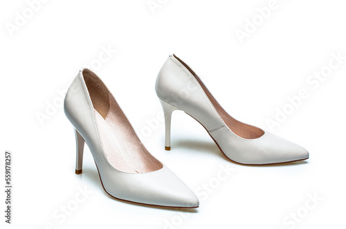 White high heel women shoes on white background. White shoe for women. Beauty and fashion concept. Fashionable women shoes isolated on white background. Stylish classic women leather shoe