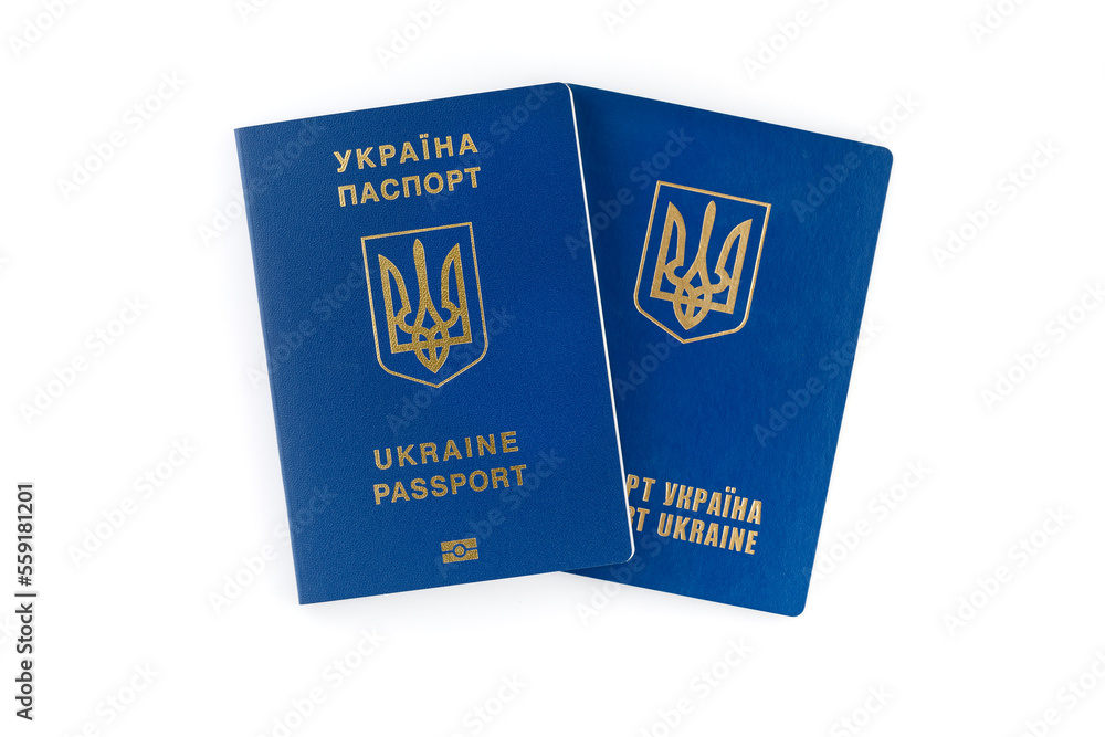 Two Ukrainian passports lie on top of each other, isolated on white background. Inscription in Ukrainian Ukraine Passport. Two Ukrainian passports lie on top of each other, isolated on white background. Inscription in Ukrainian Ukraine Passport.