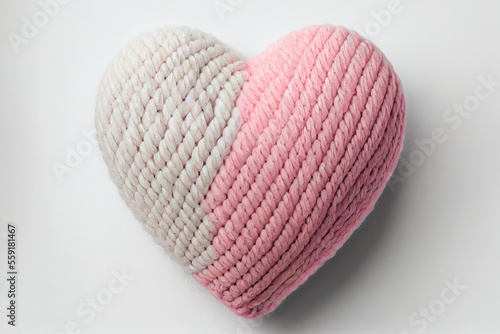 Knitted pink heart. Romantic handmade gift or decor. Close up photography created with Generative Ai technology