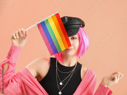 Young woman with LGBT flag on pink background, closeup