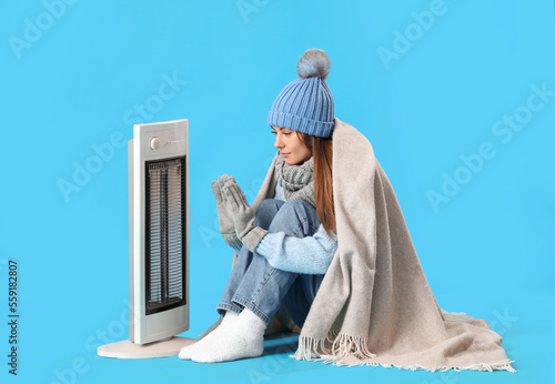 Frozen young woman warming ...
