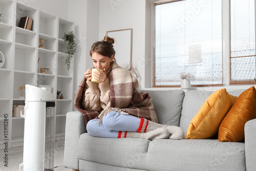 Frozen young woman with cup...