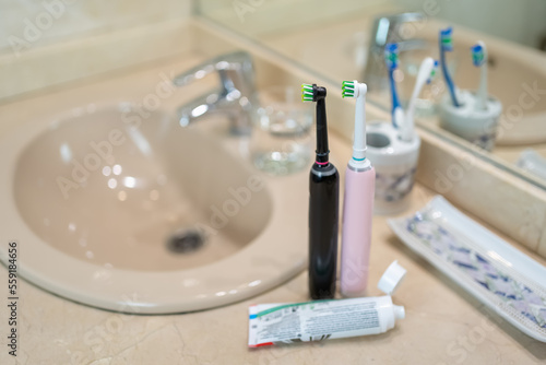Various objects used for daily oral hygiene on the countertop of a bathroom.