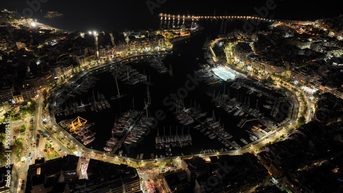 Fototapeta Naklejka Na Ścianę i Meble -  Aerial drone night shot of famous illuminated round port and marina of Zea or Pasalimani in the heart of Peiraeus, Attica, Greece