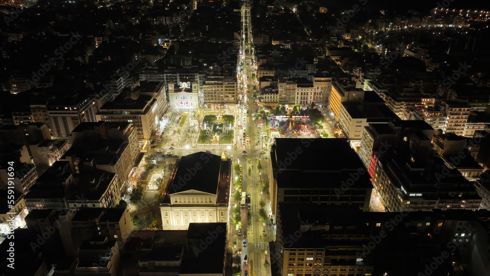 Aerial drone night shot of famous neoclassic Municipal Theatre of Piraeus and recently renovated main square of Eleftherias illuminated during Christmas period, Attica, Greece