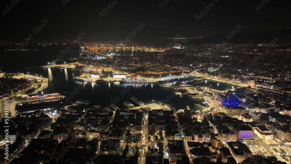 Aerial drone night shot of illuminated tower and port of Piraeus during New Year's eve celebrations, Attica, Greece Aerial drone night shot of illuminated tower and port of Piraeus during New Year's eve celebrations, Attica, Greece