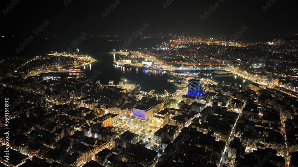 Aerial drone night shot of famous neoclassic Municipal Theatre of Piraeus and recently renovated main square of Eleftherias illuminated during Christmas period, Attica, Greece