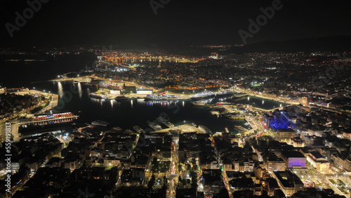 Aerial drone night shot of illuminated tower and port of Piraeus during New Year's eve celebrations, Attica, Greece © aerial-drone