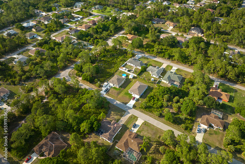 Aerial landscape view of suburban private houses between green palm trees in Florida quiet rural area