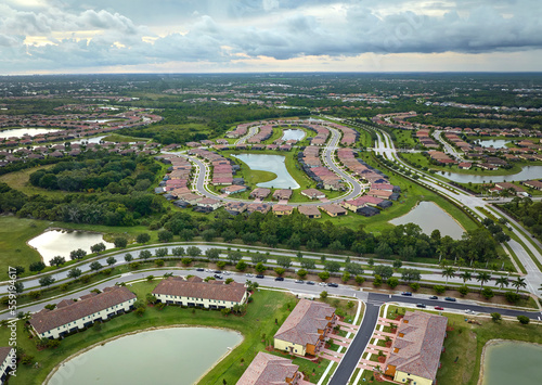 Aerial view of tightly packed homes in Florida closed living clubs. Family houses as example of real estate development in american suburbs