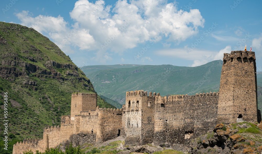 Medieval fort with hills and clouds in the background