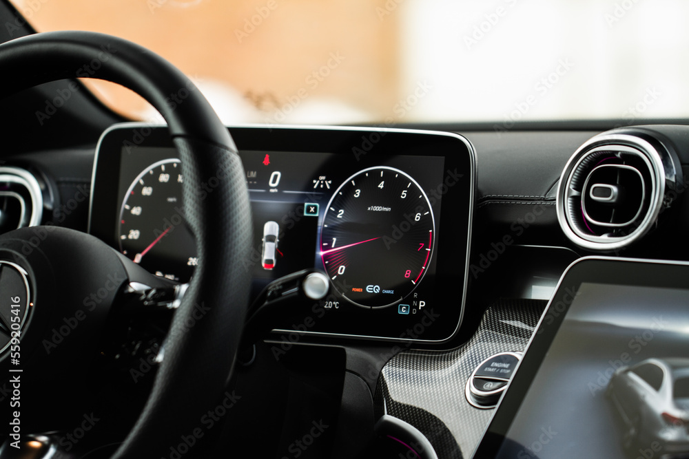 Modern car dashboard with speedometer, tachometer. Car dashboard. Car dashboard details. Modern car interior. The speedometer of a modern