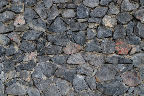 The texture of the stone wall. Old castle stone wall texture background. Stone wall as background or texture. Part of a stone wall for background or texture.