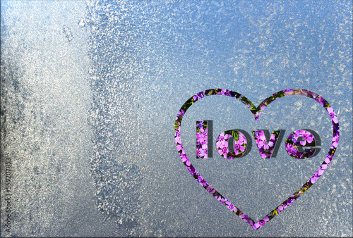 On the frozen window, silvering in the sun, is the three-dimensional word 