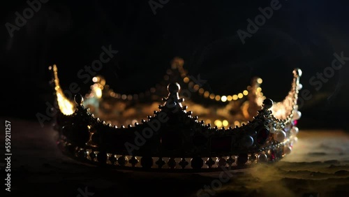 Fabulous golden crown of the king on a dark background. Panoramic view of the blue and red fog. Mockup for your logo. 