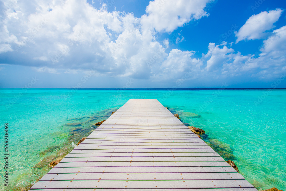 Tropical Caribbean island wooden pier with relaxing turquoise ocean in Curacao