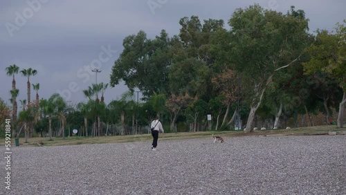 Antalya, Turkey - December 09 2022: Girl and dog