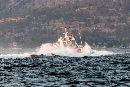 Police boat is sharply turning in the Izmir bay making a lot of splashes