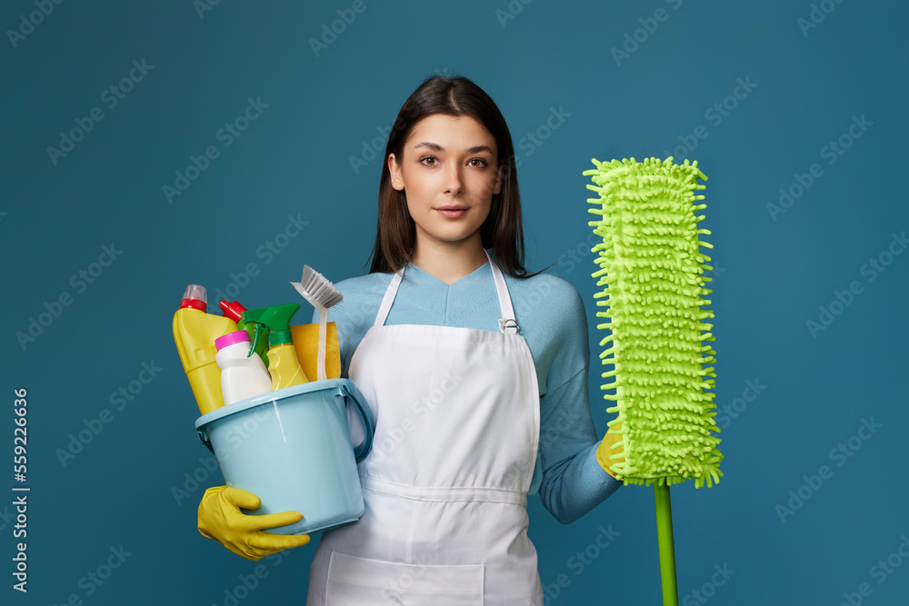 woman in cleaner apron holding bucket of detergents and mop woman in cleaner apron holding bucket of detergents and mop