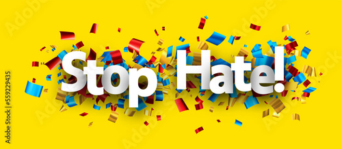 Stop hate sign over colorful cut out foil ribbon confetti background.