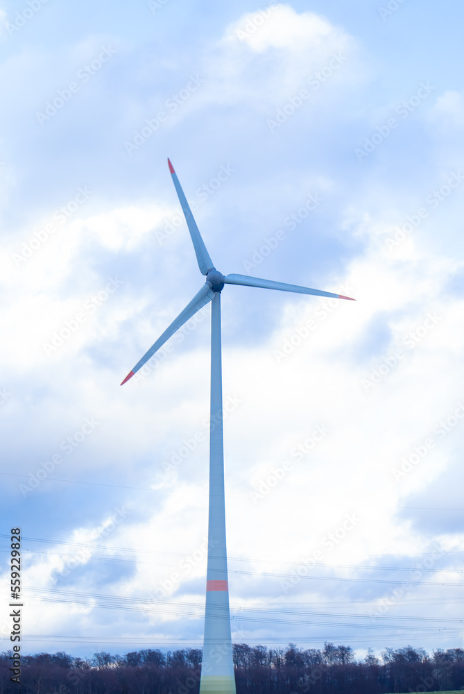 A windmill stands in a field, against the sky. Eco power plant. Concept energy, ecology, environment, light, countryside, technology, turbine, industry, europe, electricity, wind,generator,nature,eco. A windmill stands in a field, against the sky. Eco power plant. Concept energy, ecology, environment, light, countryside, technology, turbine, industry, europe, electricity, wind,generator,nature,eco.