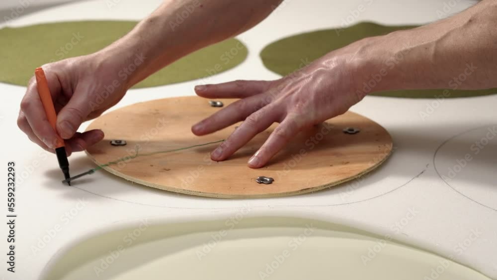 Furniture restoration. A man cuts out details from foam rubber for upholstering furniture. Close-up hands Furniture restoration. A man cuts out details from foam rubber for upholstering furniture. Close-up hands