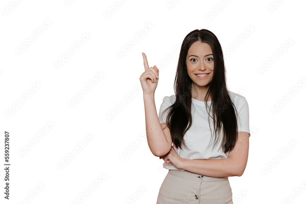 Cheerful pretty brunette in white t-shirt, beige skirt, points upward by index finger, in amazed mood, enjoys life, ready for summertime. Stands over transparent background. Sale and promotion concept Cheerful pretty brunette in white t-shirt, beige skirt, points upward by index finger, in amazed mood, enjoys life, ready for summertime. Stands over transparent background. Sale and promotion concept