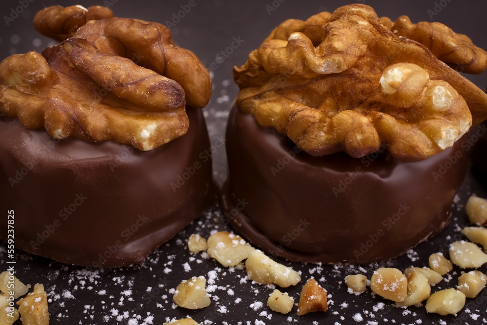 Close up of homemade with dark chocolate pralines filled with walnuts and  marzipan