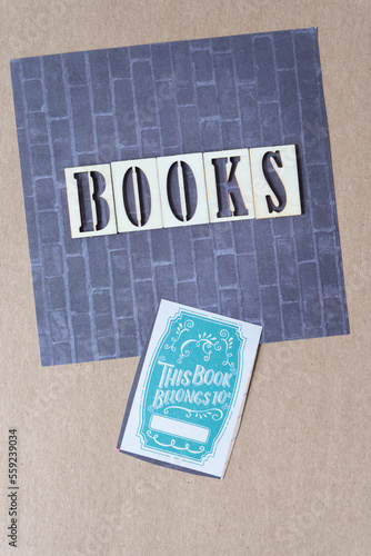 the word "books" and book plate card with text on scrapbook paper with brick wall design