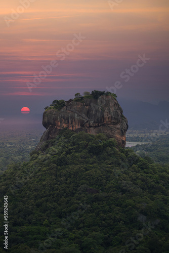 Sundown with view from Pidurangala mountain to Sigiriya Lion Rock in Sri Lanka. Landscape panorama. After climb up the hill for tourists for wonderful view point to Lion Rock.