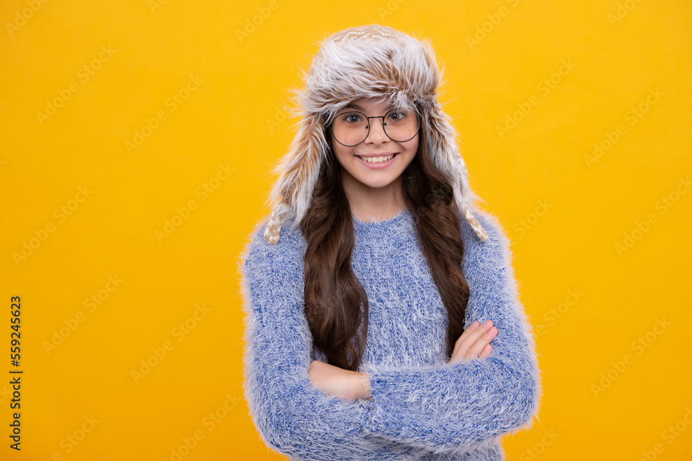 Winter hat. Cold season concept. Winter fashion accessory for children. Teen girl wearing warm knitted hat. Happy girl face, positive and smiling emotions. Winter hat. Cold season concept. Winter fashion accessory for children. Teen girl wearing warm knitted hat. Happy girl face, positive and smiling emotions.