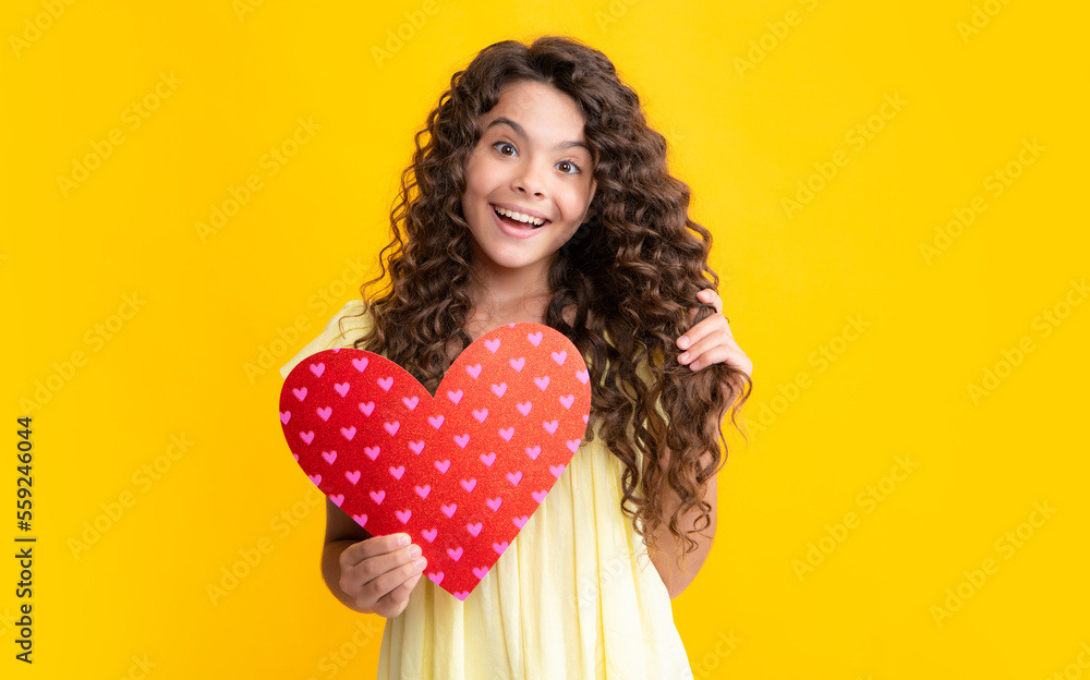 Happy teenager portrait. Valentines Day. Dreaming cute teen child with red heart. Smiling girl. Happy teenager portrait. Valentines Day. Dreaming cute teen child with red heart. Smiling girl.