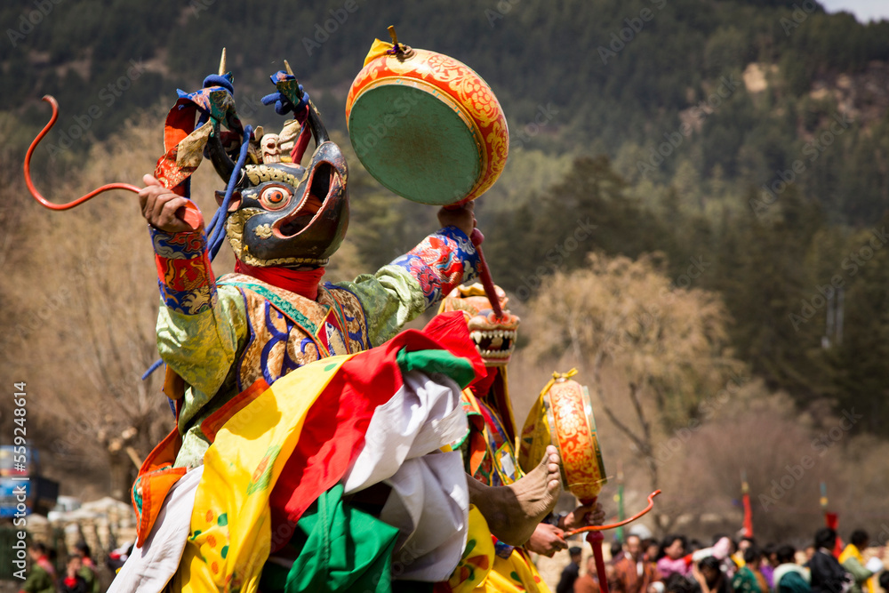 Masked Bhutanese Cham Dancers Performing at the Nomad Festival in Bumthang Dzongkhag (district) in central Bhutan Masked Bhutanese Cham Dancers Performing at the Nomad Festival in Bumthang Dzongkhag (district) in central Bhutan