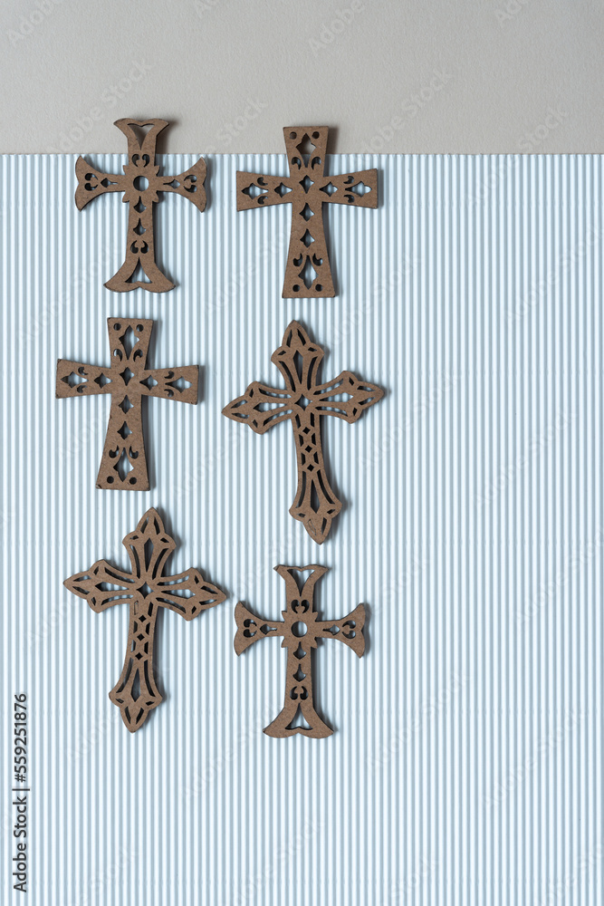 set of decorative wood crosses on corrugated paper