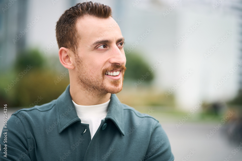 Portrait smiling man looking away on the street Portrait smiling man looking away on the street