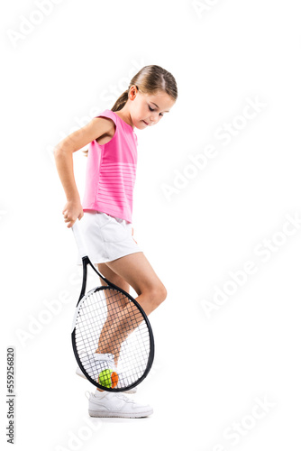 Young female tennis player in pink outfit. Little girl posing with racket and ball isolated on white background. © Nikola Spasenoski