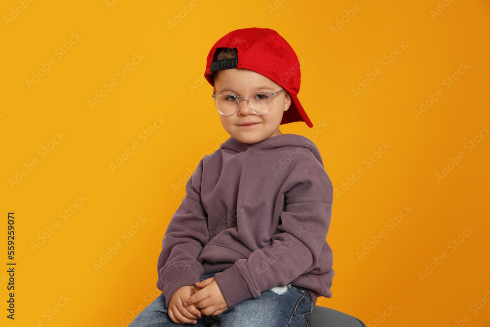 Cute little boy in glasses on orange background Cute little boy in glasses on orange background