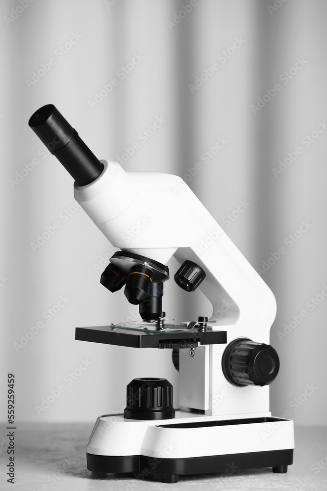 Modern microscope on table indoors. Medical equipment Modern microscope on table indoors. Medical equipment