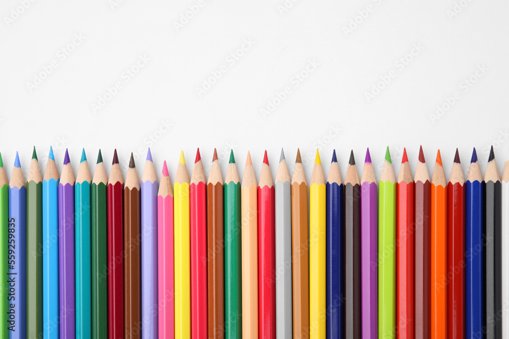Colorful wooden pencils on white background, flat lay. Space for text Colorful wooden pencils on white background, flat lay. Space for text
