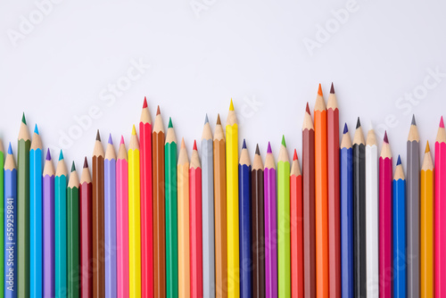 Colorful wooden pencils on white background, flat lay. Space for text