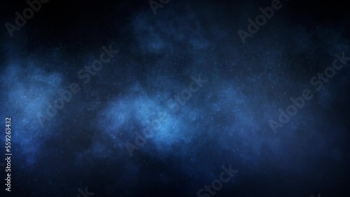 Blue Smoke Clouds and Particles Background 4K Loop features smoke cloud formations drifting down with snow-like particles in a blue atmosphere in a loop.