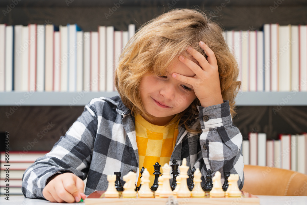 Clever thinking child. Chess for intelligent kid. Child genius, smart pupil playing logic board game. Clever school boy thinking about chess. Clever thinking child. Chess for intelligent kid. Child genius, smart pupil playing logic board game. Clever school boy thinking about chess.